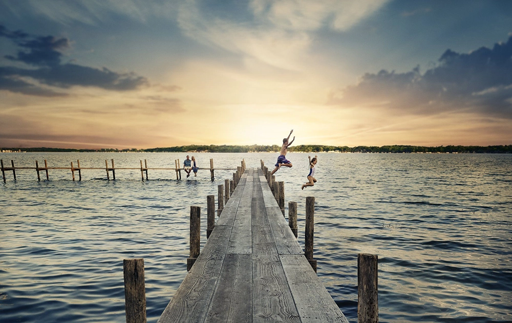 CL Dock Kids jumping into a lake off the dock